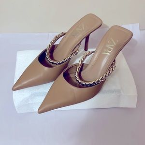 Tan color Mule shoes with gold chain and about 3” heels . Gently worn . Stylish